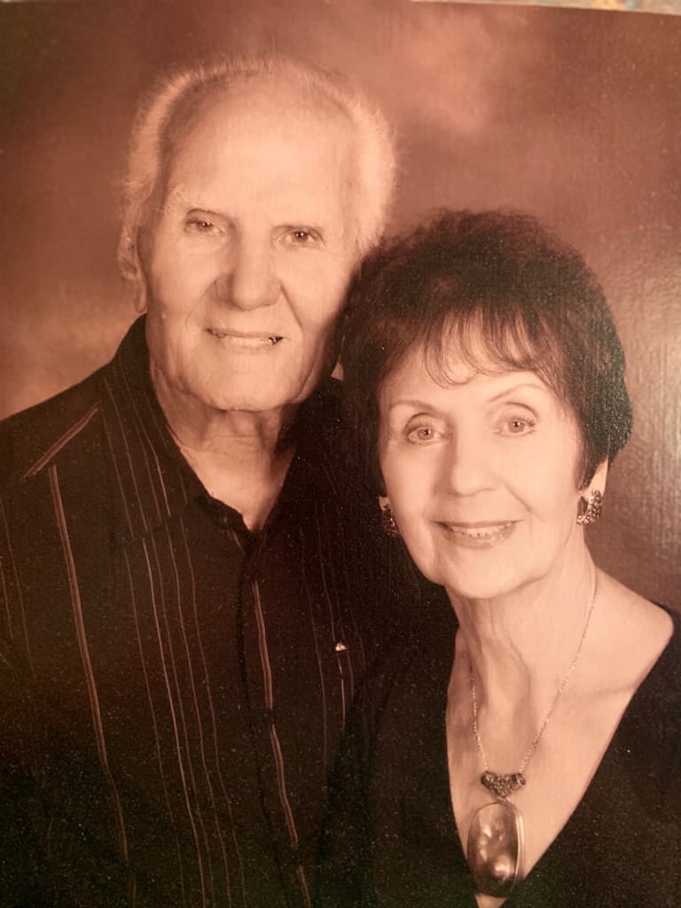 Grandma and Papa, smiling together in a studio portrait